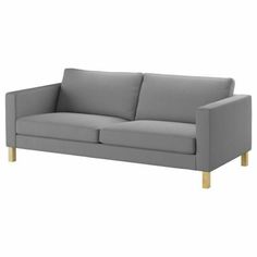 a gray couch with wooden legs on a white background