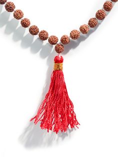 This set of Prayer Beads, a Mala or Rosary, is made of finely selected, peppercorn sized, five Mukhi Rudraksha mala beads. Thread-knotted in traditional style with red tassel, this Rudraksha rosary is best for doing Japa or chanting mantras to all deities. You may keep the healing mala in your puja altar for positive vibrations or as a garland for your deity idol. You may also wear it around your neck. It is best to avoid wearing this with other Rudraksha combinations. Measures 34 inches long wh Traditional Hand Knotted Mala For Meditation, Traditional Hand Knotted Necklaces For Meditation, Traditional Brown Mala For Rituals, Hand-strung Beaded Necklaces As Festival Gifts, Festive Hand-strung Beaded Necklaces As Gifts, Traditional Hand-strung Mala For Meditation, Adjustable Mala With Polished Beads For Meditation, Adjustable Polished Beads Mala For Meditation, Traditional Jewelry For Meditation With 8mm Beads