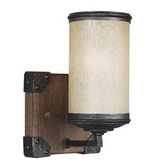 a wall light that is on the side of a wooden frame and has a white glass shade