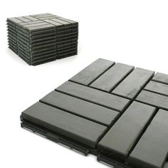 a stack of black tiles sitting next to each other