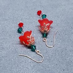 PRIMERO Crystals® RED CHRISTMAS FLOWER EARRINGS * Handmade red flower earrings * Frosted red lucite acrylic flowers measuring 10mm x 14mm * Four genuine 5mm green PRIMERO Crystals® * Two genuine 5mm red PRIMERO Crystals® * Rose gold plated components (chain, bead caps and wires) * Choice of ear wires * Rubber earring stops * Optional sterling silver ear wires are high quality solid 925 sterling silver hallmarked and a sturdy 0.8mm gauge TIME IT TAKES TO MAKE YOUR ITEM * Every single item is hand Red Christmas Flower, Red Flower Earrings, Christmas Jewellery, Acrylic Flowers, Green And Red, Red Flower, Christmas Jewelry, Bead Caps, Red Christmas