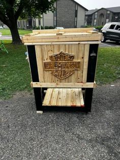 a wooden crate sitting on top of a gravel road