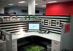 an office cubicle with black and white striped walls