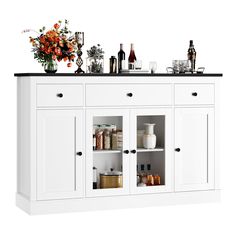 a kitchen with white cabinets and black counter tops on top of it's shelves