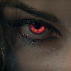 a close up of a person's eye with red eyes