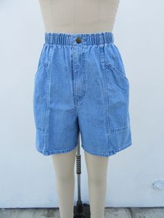 90s high waist denim shorts.  Light wash. All cotton. Elastic waist. Side pockets. Made in Mexico for CHEROKEE.  Label size Small Please compare measurements to a similar garment that fits you well Measured flat 25 to 30" elastic waist 40" hips 13-3/4" rise 6" inseam  Good + vintage condition with minimal signs of use and age. Retro High Waist Jean Shorts With Built-in Shorts, Retro High-waisted Jean Shorts With Built-in Shorts, Retro Jean Shorts With Pockets, Retro High Rise Cotton Shorts, 90s Inspired High Waist Cotton Jean Shorts, Retro High Waist Medium Wash Shorts, 90s Inspired High-waisted Cotton Jean Shorts, Retro High Waist Denim Shorts, 90s Inspired High Rise Jean Shorts