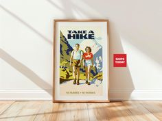 there is a framed poster on the wall next to a red sign that says take a hike