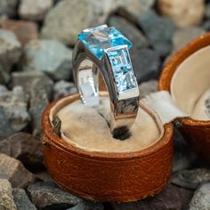 This stunning Italian made topaz ring is centered with one square step cut blue topaz that is channel set and with two square step cut topaz accents at each shoulder. The ring is crafted of 14k white gold. The lower shank has a more oval shape due to its current ring size of 8. This will not be noticed while the ring is being worn. We cannot size this ring down further, however the size can be increased. Blue Topaz Ring With Square Cut, Fine Jewelry Blue Topaz Rectangular Rings, Three-stone Blue Topaz Ring For Anniversary, Modern Topaz Ring With Rectangular Stone For Formal Occasions, Three Stone Blue Topaz Ring For Anniversary, Blue Topaz Three Stone Ring For Anniversary, Anniversary Three-stone Blue Topaz Ring, Modern Formal Topaz Ring With Rectangular Stone, Luxury Baguette-cut Topaz Ring