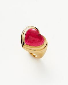 Share the love. The chubby jelly heart gemstone ring is set with a dyed pink quartz cabochon stone – known for bringing love – surrounded by signature ridge detailing on a domed band. Wear solo or stack with other chunky pieces. This piece contains a semi-precious gemstone that is natural, meaning each stone is complet Jelly Hearts, Fan Necklace, Diamond Ear Cuff, Diamond Initial Necklace, Purple Quartz, Gold And Silver Rings, Heart Gemstone, Pink Quartz, Recycled Gold