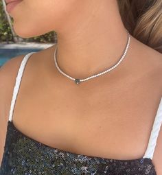 This delicate black diamond and diamond choker is a modern take on the single pendant necklace. Wear alone for a statement piece or layer with other necklaces for a bold look. 5.60ct total diamond weight 14K White Gold 1.40ct heart shaped black Diamond heart 4.20ct tw 40 round diamonds on each side of the heart 17” length with adjustable length lobster clasp closure Benefits of Solid 14k Gold Jewelry Most loved for its durability and longevity Can be worn daily and requires less maintenance and Diamond Tennis Necklace, Diamond Choker, Diamond Chain, Tennis Necklace, Black Necklace, Diamond Heart, 4 20, Lead Time, Black Diamond