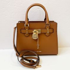 New With Tag Michael Kors Hamilton Small Satchel Shoulder Crossbody Bag Pebbled Leather Luggage 100% Authentic Retail: $368.00 Plus Tax ***Please See The Measurement For The Size*** No Dust Bag Michael Kors Logo At Front Zip Top Closure Gold Toned Hardware Mk Key & Lock On Front Custom Mk Fabric Lining 1 Slip-In Pockets 1 Zipper Pocket 10" (L) X 8"(H) X 4"(D) Strap: 4", 18"- 24" Very Clean, Smoke-Free And Pet-Free Environment. Brown Leather Satchel With Lock, Brown Shoulder Bag With Lock For Travel, Brown Bag With Lock For Everyday Use, Brown Bag With Lock For Daily Use, Brown Tote Bag With Lock, Brown Everyday Bag With Lock, Brown Travel Bag With Turn-lock Closure, Michael Kors Leather Bags With Turn-lock Closure, Luxury Michael Kors Bag With Turn-lock Closure