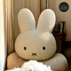 a white stuffed animal sitting on top of a chair