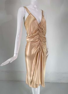 For Sale on 1stDibs - John Galliano, old Hollywood glamourous gold satin evening dress with a plunge V neckline and chiffon woven shirred center front, The back features a row Glamorous Ruched Evening Dress For Party, Ruched V-neck Satin Dress For Formal Occasions, Luxury Gold V-neck Dress, Chic Gold Evening Dress For Gala, Gold V-neck Evening Dress For Summer, Gold Backless Evening Dress For Cocktail, Gold Backless Cocktail Dress, Gold Backless Cocktail Evening Dress, Backless Ruched Satin Dress For Evening