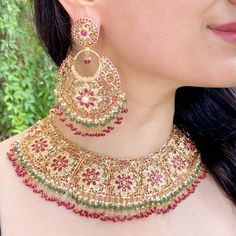 Featuring a traditional bridal jadau necklace set, paired with chandbali earrings. Handcrafted in 22 carat gold. This bridal necklace set has been set with precious rubies, emeralds and pearls. The necklace weighs 88.56 GMs including 12 GMs of hanging ruby emerald and pearl beads. The earrings weigh 48.46 GMs including 7.30 GMs of hanging ruby emerald and pearl beads. Price Breakup Summary Component Rupees % of Total 22k Gold 609,567 77.2% Stones & Beads 46,931 5.9% Making Charges 109,722 13.9% Taxes (GST) 22,987 2.9% Total 789,207 100.0% View Detailed Price Breakup Jadau Necklace Set, 22k Gold Jewelry Necklaces, Indian Gold Jewellery, Legs Mehndi, Jadau Necklace, Legs Mehndi Design, 22k Gold Jewelry, Kurti Neck, Bridal Necklace Set