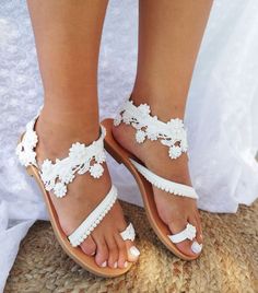 Handmade leather wedding sandals for women. These sandals are made of high  quality leather so they are elegant, comfortable and durable in time. The upper is made of white leather. These sandals are decorated with a flower lace with small pearls and a white pom pom lace. The bottom is made of white leather and the sole is anti slippery rubber in natural color.. Check out the color chart and choose any color combination you like. You can choose between natural, white or gold leather for the bott Spring Party Lace Sandals, Spring Party Sandals With Lace, Elegant Lace Wedding Shoes For Summer, Elegant Summer Wedding Shoes With Lace, Elegant Summer Wedding Shoes In Lace, Lace Ankle Strap Sandals For Spring, Spring Lace Ankle Strap Sandals, Spring Ankle Strap Lace Sandals, Elegant Lace Open Toe Sandals