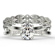 a wedding ring set with an oval cut diamond in the center and two matching bands