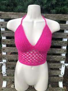 Handmade bright fuscia pink crochet halter crop top with a cute fishnet pattern.  One-of-a-kind freehanded pattern! Very stretchy and adjustable and fits a variety of different sizes and shapes. Also made with thick and sturdy triple back ties and neck ties. Perfect for spring, summer, concerts, raves, festivals or just everyday wear! Photos taken in natural lighting Pink Halter Neck Crochet Top For Beach, Stretch Pink Crochet Beach Top, Fitted Pink Crop Top For The Beach, Pink Stretch Halter Top For Festival, Stretch Pink Halter Top For Festivals, Pink Crochet Halter Top For Spring, Stretch Pink Crochet Top, Spring Pink Crochet Halter Top, Stretch Crochet Top In Pink