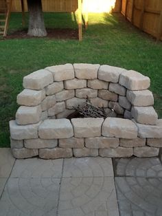 an outdoor fire pit made out of stones