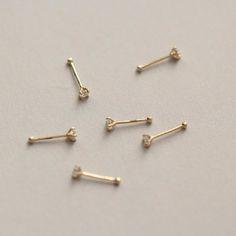 Style A tiny and cute 14K gold nose stud, without breaking the bank. You could never go wrong with such a classic design. It is a dazzling symbol of your personality. Metal It is made of 14K yellow gold. 14K gold contains 58.5% gold and 41.5% alloy. Compared to 10K, 18K, and 24K, it is the most popular choice, nearly 90% of all wedding rings and engagement rings sold in the United States consist of 14K gold. It’s durable and will not easily tarnish. Packaging It is ready as a gift! This 14K gold nose bone stud is made with love and will arrive in a jewelry box. Whether for yourself or for the one you love, it is an excellent choice. Tiny Dainty 14k Gold Nose Studs, Dainty Hypoallergenic Yellow Gold Nose Stud, 14k Gold Nose Studs With Prong Setting Gift, 14k Gold Prong Setting Nose Studs For Gift, Dainty Yellow Gold Nose Studs For Gift, Dainty Yellow Gold Nose Studs As Gift, Dainty Gold Piercing With Single Diamond, Elegant Tiny Yellow Gold Nose Studs, Dainty Yellow Gold Piercings With Single Diamond