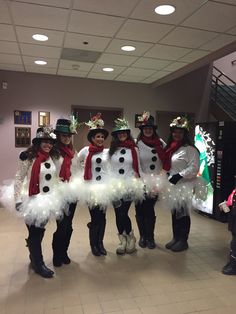 four girls dressed up as snowmen in costumes