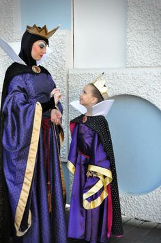 two people dressed in costumes standing next to each other