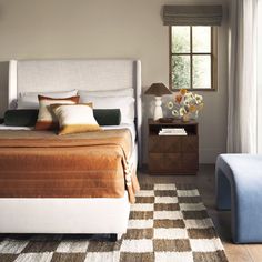 a bed sitting next to a window in a bedroom