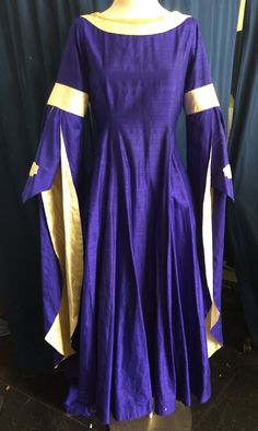 The dress in these pictures is ready to ship right away.  It has a maximum 41" bust and 30" waist. It was used in one performance  of Camelot, and has been dry cleaned, so there is a discount if this one fits you. These tend to look best if you have a little wiggle room.  This is not stretchy, and it does not lace up the back, so please check your measurements before you order. Other sizes and styles, or an exact replica of this one, are available as a custom order which takes 6-8 weeks. We will Elegant Fitted Blue Medieval Dress, Historical Design Fitted Long Sleeve Dress, Elegant Blue Medieval Dress, Historical Design Dress With Fitted Bodice For Fancy Dress, Royal Style Fitted Fancy Dress, Royal Fitted Dress For Formal Occasions, Fancy Dress With Historical Design And Fitted Bodice, Royal Fitted Fancy Dress, Royal Long Sleeve Costume Dresses