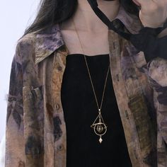 Embrace the beauty of the cosmos with this unique micro planet orbit necklace. Crafted from brass, the necklace captures the essence of the solar system, adding a touch of celestial elegance to your look. This necklace is meticulously designed to represent the intricate movements of planets. The brass material gives a timeless appeal, ensuring a durable and stylish accessory for any occasion. Perfect for both casual and formal settings, this solar system necklace adds a unique flair to any outfi Mystical Gold Electroformed Jewelry, Mystical Brass Pendant Necklaces, Mystical Brass Pendant Necklace, Moon Phase Brass Pendant Necklace, Mystical Brass Round Necklaces, Planet Orbit, Solar System Necklace, Planet Necklace, Space Lovers