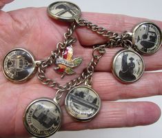 a person is holding onto some charms in their hand and it looks like they are from the past