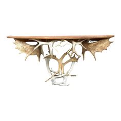 a wooden table topped with antlers and leaves