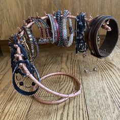 several bracelets and bangles on a wooden floor