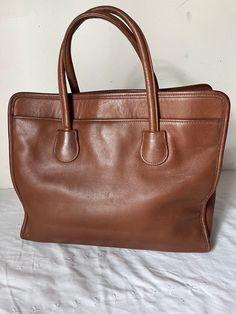 Coach Vintage Cognac Leather Handbag C7C-7302 Bag Brown Handbag Tote Purse.  15" X 10" X 8". Strap drop full: 12.5". You can see the amazing quality of the leather of this bag.  In great condition, See pictures as any problems will be shown in the pictures. Please know that this is a used item, and might show some wear. ITEM IN PICTURE IS WHAT YOU WILL RECEIVE. Shipping: I provide free shipping insured by USPS. I am not responsible for any item after it is with USPS. Returns: I accept returns, but the buyer must pay for return shipping regardless of the reason for return. Items must be returned within 14 days of receipt. Combined shipping: I am happy to combine shipping for multiple purchases for free. Brown Shopping Bag With Detachable Handle, Classic Shoulder Bag For Shopping, Classic Handheld Briefcase For Daily Use, Elegant Large Travel Bag, Classic Brown Bag With Double Handle, Classic Cognac Shoulder Bag With Detachable Handle, Classic Brown Bag With Detachable Handle, Classic Brown Bag With Leather Handles, Classic Laptop Bag With Detachable Handle For Travel