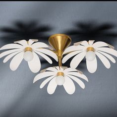 a ceiling light with three white flowers on it