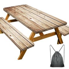 a picnic table with two benches next to it and a drawstring bag on the floor