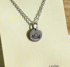 "Tiny charm. Nickel free. 16\" -18\" adjustable stainless steel silver chain. Does not fade or turn.  Disclaimer: because this is a handmade necklace, the stamping will not be exact. Each item is a little unique to itself. We will make it as close to the same as humanly possible.  Thank you so much! We sure appreciate you and your business.  Please message with any questions or concerns." Tiny Charm, Appreciate You, Cowboy Hat, Handmade Necklace, Wild West, Handmade Necklaces, Cowboy Hats, Charm Necklace, Silver Chain