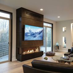 a living room filled with furniture and a flat screen tv mounted to the side of a wall