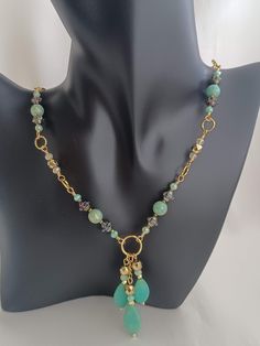 This is a beautiful hand wire-wrapped necklace that will accentuate your formal or casual attire.  It has some pretty vintage Czech turbine beads which paired with the rest of beads make it a one-of-a-kind jewelry piece.  I hand wire-wrapped each bead segment with gold tone Artistic wire in 22 gauge.  This necklace has green Czech glass beads with a gold shimmer, vintage Czech glass turbine beads, Hematite stones in gold luster, and crystal beads.  The focal is made of 3 beaded dangles with semi-precious Magnesite flat teardrop beads, Hematite gold stones, and crystals.  The vintage Czech turbine beads have an interesting base color, between black and vintage bronze depending on the lighting, and they have a peacock luster finish.  I finished the necklace with a golden stainless steel lobs Wire Wrapped Teardrop Necklaces For Jewelry Making, Bohemian Dangle Necklace With Faceted Beads, Wire Wrapped Teardrop Pendant Necklace For Jewelry Making, Elegant Wire Wrapped Dangle Beaded Necklaces, Bohemian Teardrop Wire Wrapped Necklace, Elegant Teardrop Pendant Beaded Necklace, Czech Glass Dangle Necklaces With Dangling Beads, Beaded Chain Necklace With Teardrop Pendant For Jewelry Making, Adjustable Drop Necklace With Dangling Beads