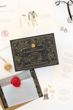 the wedding stationery is laid out on top of the table with scissors and other items