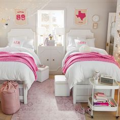 two white beds with pink blankets in a girls'bedroom decorated for valentine's day