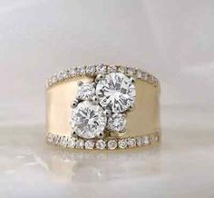 two diamond rings on top of each other, one with three diamonds in the middle