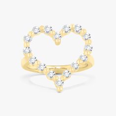 a heart shaped ring with diamonds in the middle and two smaller hearts on each side