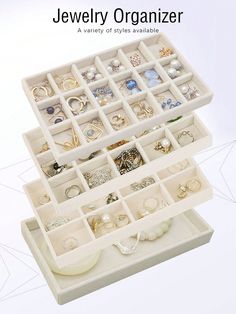 the jewelry organizer is organized with white trays