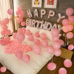 pink balloons and streamers are on the bed in this bedroom decorated for a birthday