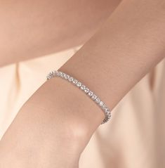 Tennis Bracelet | S925 Sterling Silver, Simulated Diamond Bracelet | Gifted Jewelry 𝐃𝐞𝐬𝐜𝐫𝐢𝐩𝐭𝐢𝐨𝐧 ✧ 𝐏𝐫𝐞𝐦𝐢𝐮𝐦 𝐐𝐮𝐚𝐥𝐢𝐭𝐲 𝐌𝐚𝐭𝐞𝐫𝐢𝐚𝐥: Crafted from high-quality S925 sterling silver for lasting shine and durability. ✧ 𝐂𝐮𝐛𝐢𝐜 𝐙𝐢𝐫𝐜𝐨𝐧𝐢𝐚 𝐒𝐭𝐨𝐧𝐞𝐬: Each CZ stone is carefully selected to mimic the brilliance of real diamonds, providing an ethical and affordable luxury. ✧ 𝐂𝐥𝐚𝐬𝐬𝐢𝐜 𝐒𝐭𝐲𝐥𝐞: The iconic tennis bracelet design ensures it complements any outfit. ✧ 𝐏𝐞𝐫𝐟𝐞𝐜𝐭 𝐆𝐢𝐟𝐭: Elegantly packaged, making it an ideal gift for any occasion. Elevate your style with our Tennis Bracelet, where sophistication meets affordability. 𝐒𝐩𝐞𝐜𝐢𝐟𝐢𝐜𝐚𝐭𝐢𝐨𝐧𝐬 − 𝐌𝐞𝐭𝐚𝐥: S925 Sterling Silver − 𝐅𝐢𝐧𝐢𝐬𝐡: Silver, Gold, Rose Gold − 𝐒𝐢𝐳𝐞: 6in, 7 Tennis Bracelet Silver, Classic Sterling Silver Bracelet With Prong Setting, Timeless White Gold Tennis Bracelet, Classic Sterling Silver Bracelet In Diamond White, Classic Diamond White Sterling Silver Bracelet, Formal Minimalist Tennis Bracelet, Fine Jewelry Tennis Bracelet For Formal Occasions, Formal Cubic Zirconia Chain Bracelet, Classic Sterling Silver Cubic Zirconia Bangle