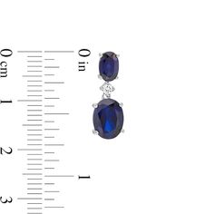 A timeless addition to her wardrobe, these fashion drop earrings are a style must-have. Crafted in sterling silver, each earring showcases an 8.0 x 6.0mm oval-shaped lab-created bright blue sapphire dangle suspended from a shimmering lab-created white sapphire. A 6.0 x 4.0mm oval-shaped created blue sapphire post completes this charming design. Buffed to a brilliant luster, these earrings secure comfortably with friction backs. Elegant Oval Pendant Earrings For Anniversary, Timeless Oval Gemstone Earrings, Timeless Oval Sterling Silver Earrings, Timeless Oval Hallmarked Earrings, Formal Oval Pendant Gemstone Earrings, Sapphire Oval Sterling Silver Earrings, Sapphire Color Oval Sterling Silver Earrings, Oval Sapphire Earrings In Sterling Silver, Oval Sapphire Sterling Silver Earrings