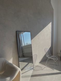 a room with a chair and a mirror in it