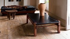 a living room filled with furniture and a large vase