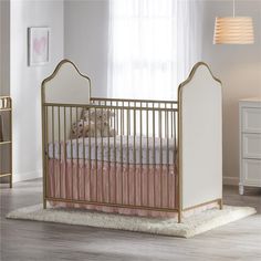 a baby crib with pink and white bedding