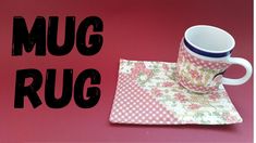 there is a coffee cup on the table next to a napkin with the word mug rug written across it