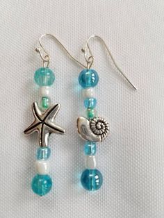 Mismatched Starfish and Shell Earrings.  Shiny and Blue looks so beachy.   These earrings would look great with a matching beaded beachy bracelet.  The piece of jewelry for those who love the beach!  FREE domestic shipping! Starfish-shaped Beaded Beach Jewelry, Beachy Jewelry For Beach Party, Ocean-inspired Jewelry For Beach Party, Ocean-inspired Strand Jewelry For Beach Party, Coastal Style Jewelry For Summer Beach Parties, Ocean-inspired Jewelry For Beach Vacation, Coastal Style Jewelry For Beach Parties In Summer, Ocean-inspired Summer Beach Jewelry, Blue Summer Jewelry With Starfish Charm